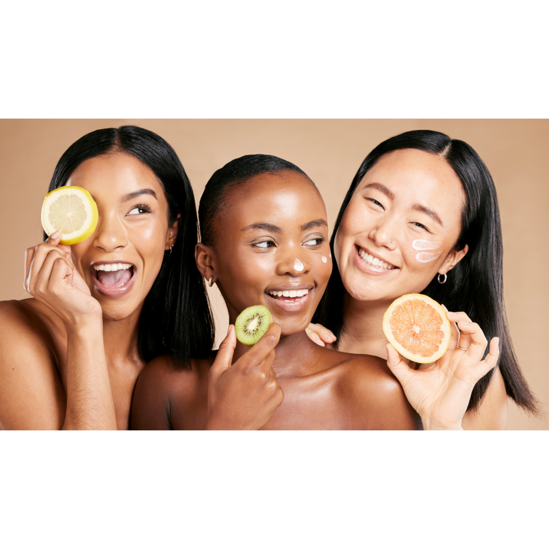 Three radiant women holding citrus slices