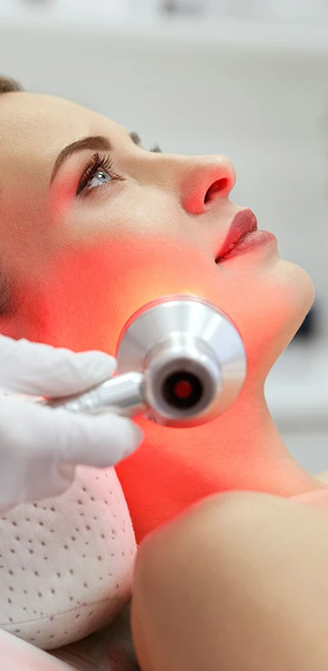 Wellness Care Lawrenceville GA Red Light Therapy On Woman's Face